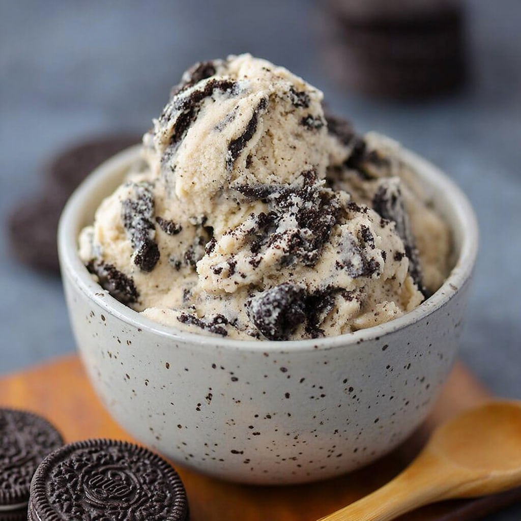 Lighter edible Oreo cookie dough scooped into balls on parchment paper