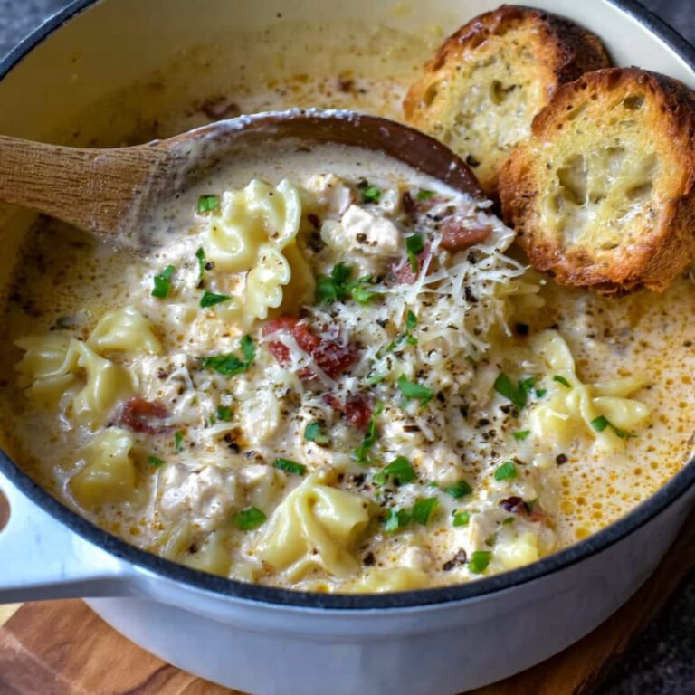 Creamy Italian ground chicken soup in a white bowl, white beans, wilted spinach, ground chicken, glossy parmesan-cream broth, crusty bread on the side, warm morning light