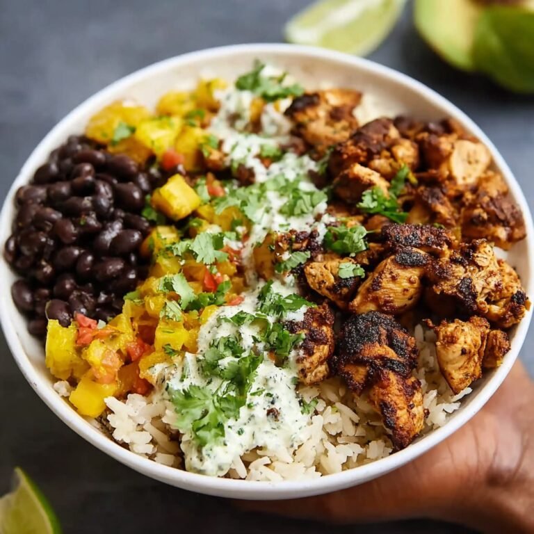 Cuban chicken rice bowl with mojo-marinated chicken thighs over cilantro-lime rice with seasoned black beans, plantains, and avocado