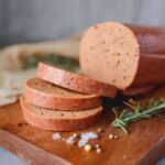Best vegan bologna recipe showing perfect slices on a sandwich board
