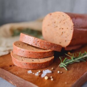 Best vegan bologna recipe showing perfect slices on a sandwich board